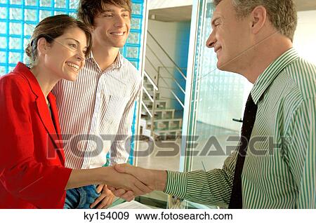 Business people shaking hands in office, smiling View Large Photo Image Stock Photo - Business people shaking hands in office, smiling. Fotosearch