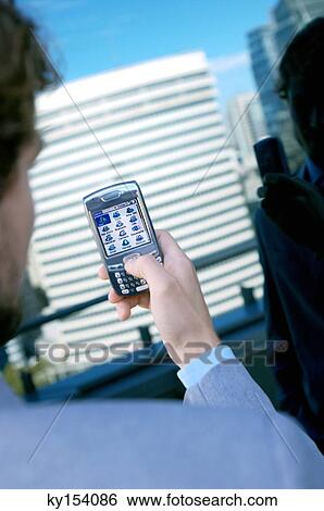 Businessman using mobile phone, rear view View Large Photo Image Stock Photograph - Businessman using mobile phone, rear view. Fotosearch