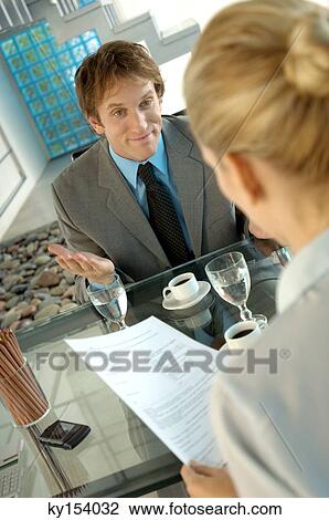 Businesswoman and business woman talking in office View Large Photo Image Stock Image - Businesswoman and business woman talking in office. Fotosearch