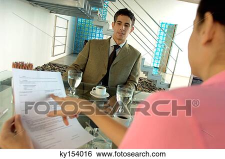 Businesswoman conducting interview in office View Large Photo Image Stock Photograph - Businesswoman conducting interview in office. Fotosearch