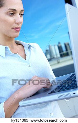 Stock Photography - Businesswoman using laptop. Fotosearch