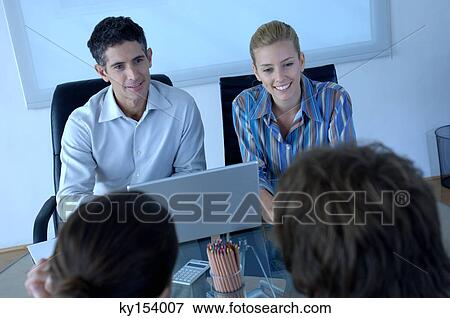 Businesswomen people discussing in office, smiling View Large Photo Image Stock Photo - Businesswomen people discussing in office, smiling. Fotosearch