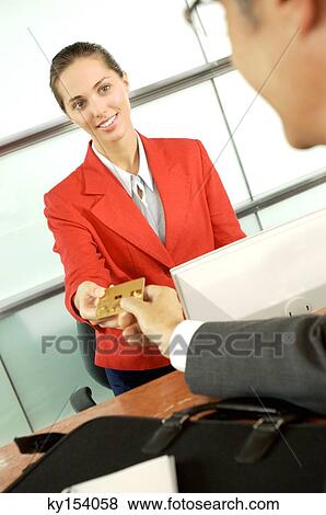 Stock Photo - Executive taking credit card from customer. Fotosearch