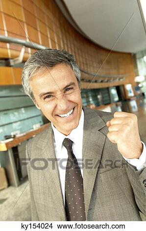 Mature businessman smiling in office, portrait View Large Photo Image Picture - Mature businessman smiling in office, portrait. Fotosearch