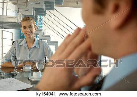 Young woman sitting in office View Large Photo Image Stock Image - Young woman sitting in office. Fotosearch
