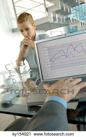 Young woman sitting in office with her hand on chin View Large Photo Image Stock Image - Young woman sitting in office with her hand on chin. Fotosearch