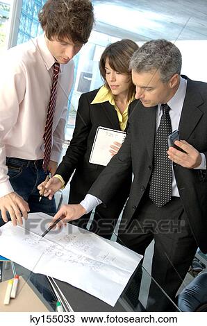 Stock Image - Business people discussing in office. Fotosearch