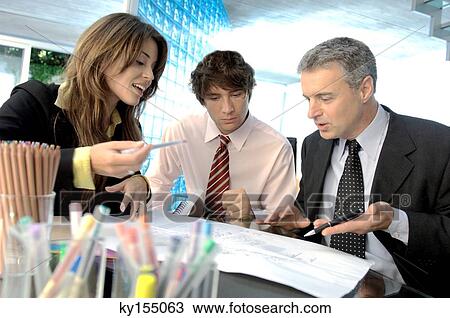 Stock Image - Business people discussing in office. Fotosearch