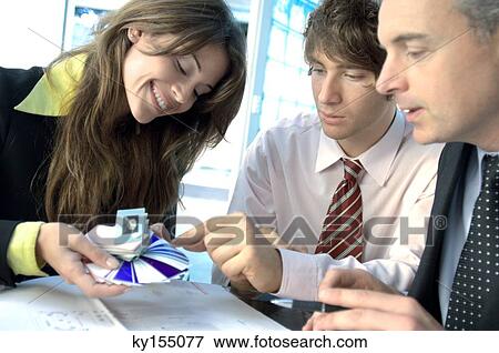 Stock Photo - Business people discussing in office. Fotosearch