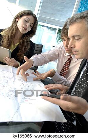 Stock Photograph - Business people discussing in office. Fotosearch