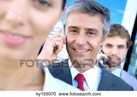 Business people using mobile phones, smiling View Large Photo Image Stock Image - Business people using mobile phones, smiling. Fotosearch