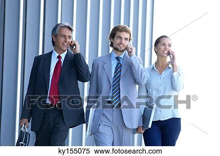 Stock Photography - Business people using mobile phones, smiling. Fotosearch