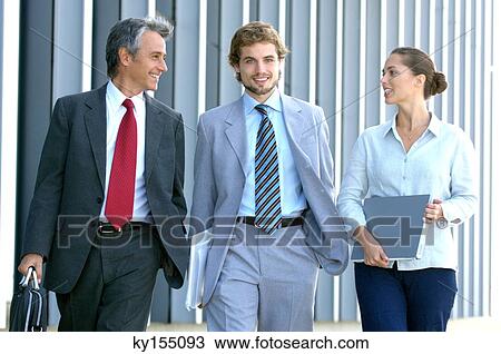 Business people walking together, smiling, portrait View Large Photo Image Stock Image - Business people walking together, smiling, portrait. Fotosearch