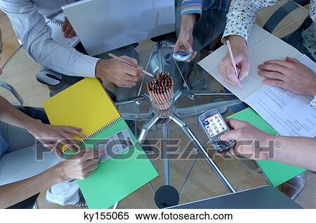Business people working in office, overhead view View Large Photo Image Stock Photography - Business people working in office, overhead view. Fotosearch