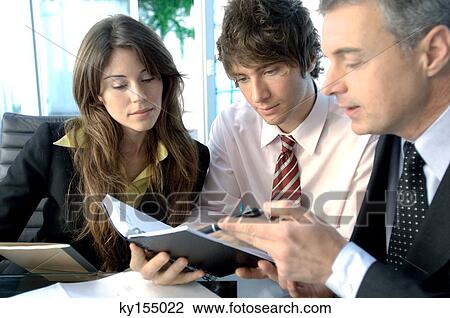 Stock Image - Businessmen and businesswoman in office. Fotosearch