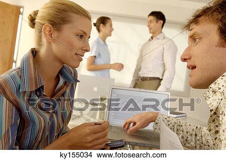 Picture - Businesspeople discussing in office. Fotosearch