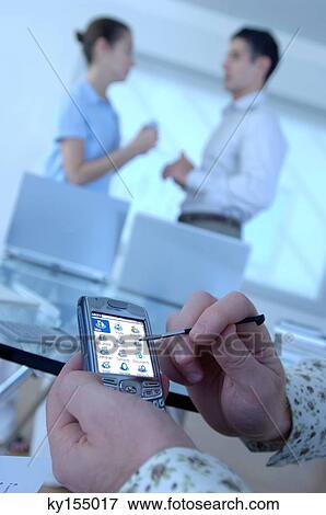 Stock Photo - Man operating mobile phone. Fotosearch