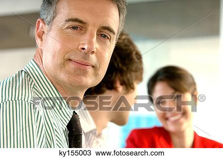 Mature businessman in office, smiling View Large Photo Image Stock Image - Mature businessman in office, smiling. Fotosearch