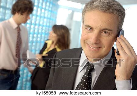 Mature man using mobile phone, smiling, portrait View Large Photo Image Stock Photo - Mature man using mobile phone, smiling, portrait. Fotosearch