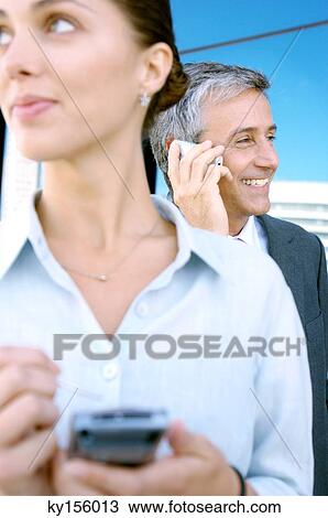 Business people using mobile phones View Large Photo Image Stock Image - Business people using mobile phones. Fotosearch