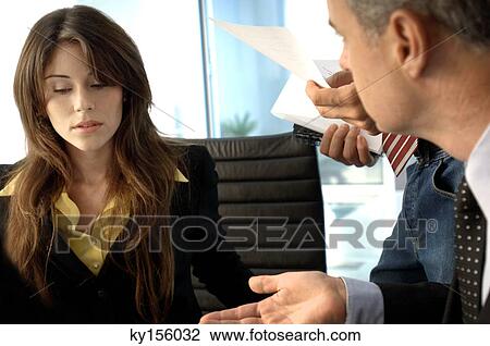 Businessman discussing with colleagues in office View Large Photo Image Stock Image - Businessman discussing with colleagues in office. Fotosearch
