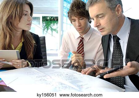 Businessman discussing with colleagues in office View Large Photo Image Stock Image - Businessman discussing with colleagues in office. Fotosearch