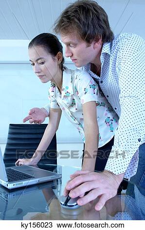 Businessman touching businesswoman's hand in office View Large Photo Image Stock Image - Businessman touching businesswoman's hand in office. Fotosearch