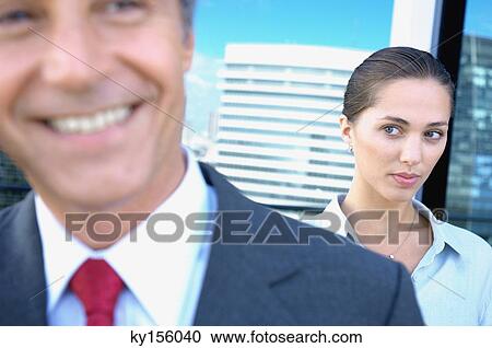 Businesswoman staring at businessman in office View Large Photo Image Stock Image - Businesswoman staring at businessman in office. Fotosearch