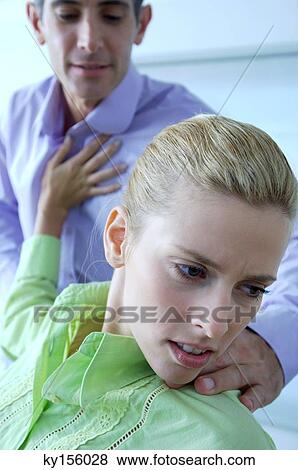 Female executive pushing male colleague in office View Large Photo Image Stock Photo - Female executive pushing male colleague in office. Fotosearch