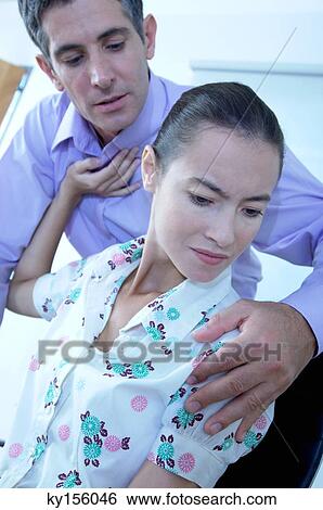Female executive pushing male colleague in office View Large Photo Image Stock Photograph - Female executive pushing male colleague in office. Fotosearch