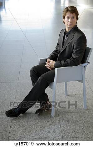 Businessman sitting in an armchair View Large Photo Image Stock Photo - Businessman sitting in an armchair. Fotosearch