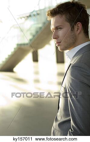 Stock Image - Businessman standing in an office. Fotosearch