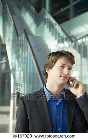 Businessman talking on a mobile phone View Large Photo Image Stock Photo - Businessman talking on a mobile phone. Fotosearch