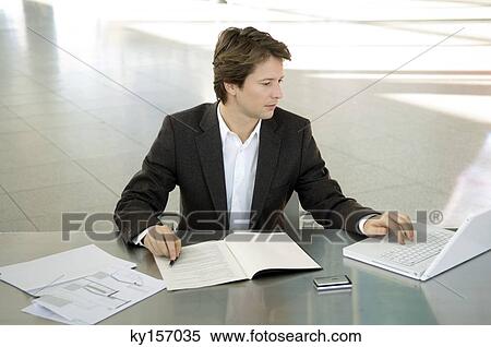 Businessman working on a laptop View Large Photo Image Stock Photography - Businessman working on a laptop. Fotosearch
