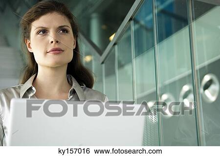 Businesswoman with a laptop View Large Photo Image Stock Photograph - Businesswoman with a laptop. Fotosearch