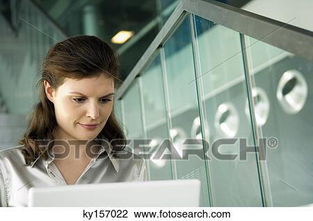 Businesswoman working on a laptop View Large Photo Image Stock Image - Businesswoman working on a laptop. Fotosearch
