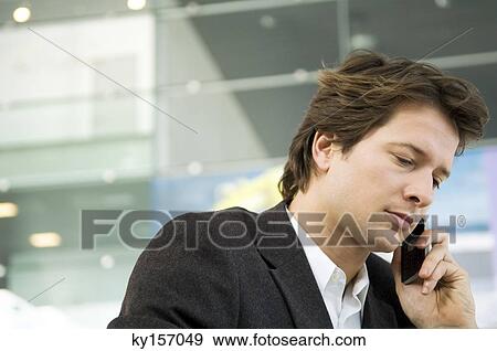 Close-up of a businessman talking on a mobile phone View Large Photo Image Stock Photo - Close-up of a businessman talking on a mobile phone. Fotosearch