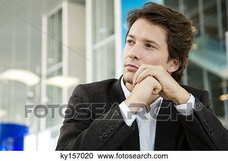 Close-up of a businessman thinking View Large Photo Image Stock Image - Close-up of a businessman thinking. Fotosearch