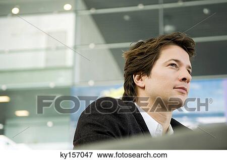 Close-up of a businessman thinking View Large Photo Image Stock Photo - Close-up of a businessman thinking. Fotosearch
