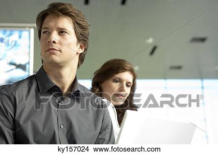 Close-up of a businessman with a businesswoman beside him View Large Photo Image Picture - Close-up of a businessman with a businesswoman beside him. Fotosearch