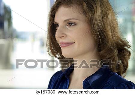 Close-up of a young woman smiling View Large Photo Image Stock Image - Close-up of a young woman smiling. Fotosearch