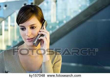 Stock Photo - Close-up of a young woman talking on a mobile phone. Fotosearch