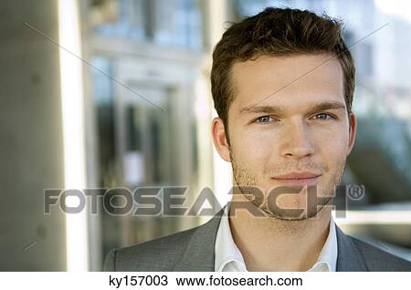 Stock Image - Portrait of a businessman smirking. Fotosearch