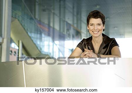 Portrait of a mid adult woman at a hotel reception counter View Large Photo Image Picture - Portrait of a mid adult woman at a hotel reception counter. Fotosearch