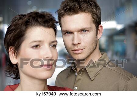 Young man and a mid adult woman looking away View Large Photo Image Stock Image - Young man and a mid adult woman looking away. Fotosearch