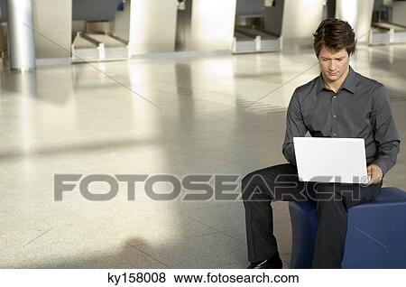 Businessman using a laptop View Large Photo Image Stock Photo - Businessman using a laptop. Fotosearch