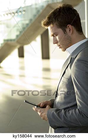 Businessman using a mobile phone View Large Photo Image Picture - Businessman using a mobile phone. Fotosearch