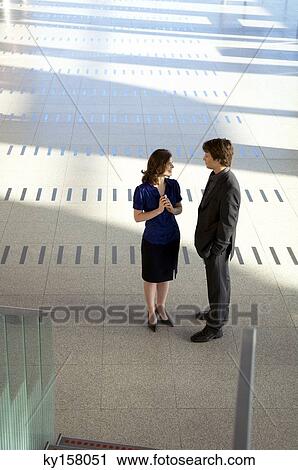 High angle view of a businesswoman talking with a businessman View Large Photo Image Stock Image - High angle view of a businesswoman talking with a businessman. Fotosearch