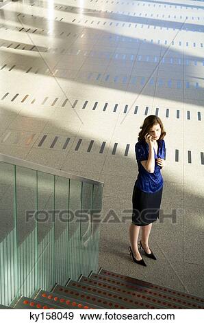 Stock Photo - High angle view of a businesswoman talking on a mobile phone. Fotosearch