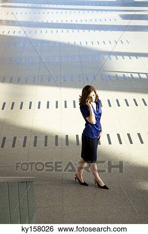 Stock Photograph - High angle view of a businesswoman talking on a mobile phone. Fotosearch